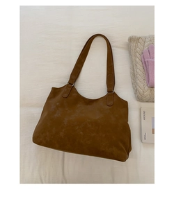 Detail view of large brown suede tote bag with durable silver rings and shoulder straps