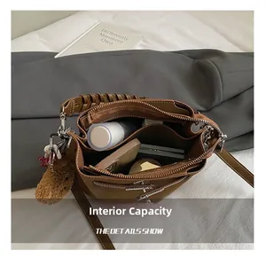 Detail view of brown suede bucket bag interior showing spacious storage for essentials