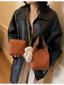 Brown lychee textured bucket bag and pouch set with rabbit charm and crossbody strap