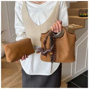 Brown frosted leather tote set with contrast stitching and dachshund bag charm decoration