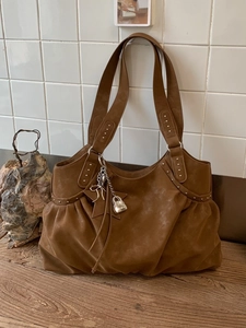 Vintage brown faux suede tote bag with silver studs and decorative metallic charms
