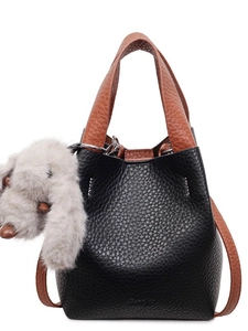 Two-tone bucket handbag in black and brown lychee grain leather with plush dog charm