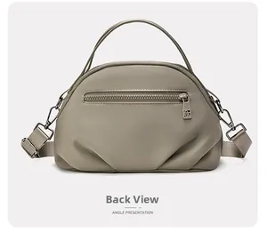 Detailed back view of khaki shoulder bag showing rear zipper pocket and strap