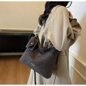 Detail of dark gray matte tote bag with small detachable pouch for daily commute