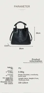 Detail view of woven black tote bag with dimensions 24x21x9cm and adjustable strap