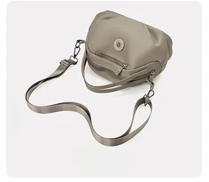 Top view of a grey nylon crossbody bag with dual parallel zippers and adjustable strap