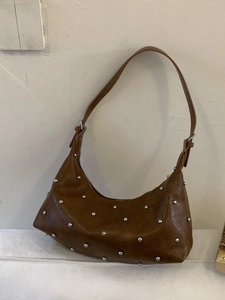 Brown vintage faux leather underarm bag with silver studs and crescent moon shape
