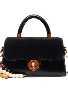 Minimalist black leather crossbody bag with vintage bronze buckle and wooden bead charm