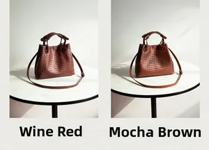 Detail view of woven leather bucket bags in burgundy and mocha brown with round handles