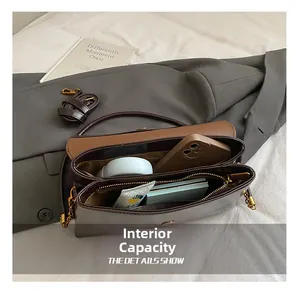 Internal view of a retro small square bag showing large capacity and multi-compartments