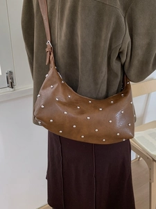 Brown moon-shaped rivet shoulder bag made of premium PU leather with adjustable strap