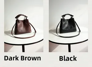 Detail view of woven bucket bags in dark brown and black colors with top handles