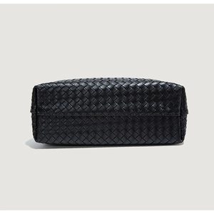 Detailed view of the intricate black woven leather texture and sturdy rectangular base