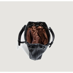 Detailed top view showing the woven leather bucket bag interior and drawstring closure