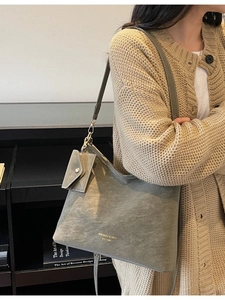 Vintage green suede tote bag with gold logo and shoulder strap for women's daily commute
