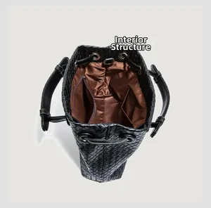 Macro view of woven handbag interior featuring brown silk lining and zip pocket