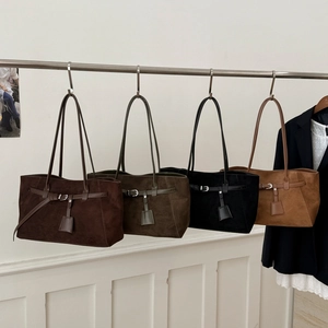 Retro faux suede tote bags in four colors hanging on a rack for casual everyday style