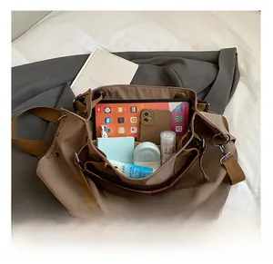 Top view showing the spacious interior of the khaki canvas tote bag with various items