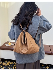 Vue détaillée d'un sac à dos vintage en cuir marron avec fermeture éclair et boucles en métal