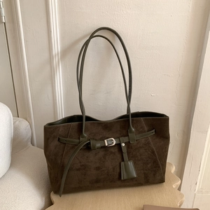 Close-up of deep brown suede tote with olive green leather straps and silver buckle