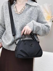 Women's black nylon crossbody bag with pleated design and adjustable strap for commuting