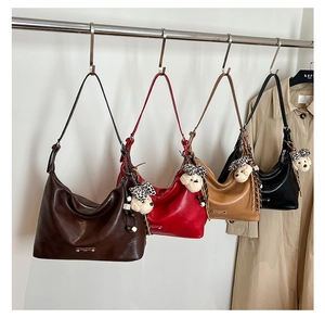 Collection of hobo shoulder bags in brown, red and black with leopard bow puppy charms