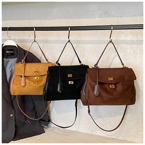 Detailed view of vintage matte leather tote bags in camel, black and dark brown tones