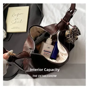 Interior view of brown PU leather hobo bag showing spacious compartment with daily items
