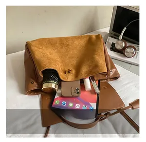 Top-down view of large brown leather tote bag showing spacious interior with everyday items