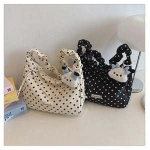 Chic polka dot pleated tote bags featuring cute plush charms and logo details