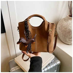 Brown frosted leather bucket bag with dachshund charm and contrast stitching detail