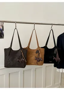 Three colors of large tote bags with dachshund charms hanging on a metal display rack