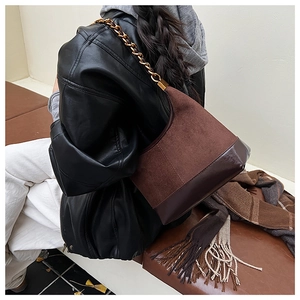 Close-up of retro dark brown hobo bag featuring mixed suede and glossy leather textures