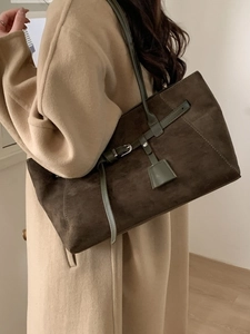 Deep brown matte suede tote bag with decorative buckle strap and long shoulder handles
