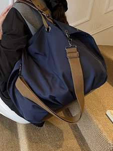 Navy blue large capacity canvas tote bag with wide shoulder strap for daily commuting