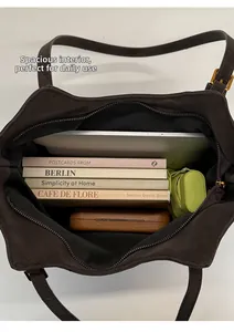 Internal view of dark coffee tote bag showing large capacity for books and tablet