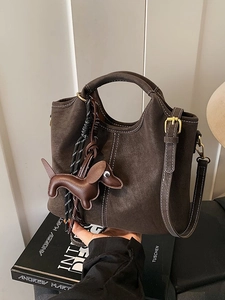 Retro dark brown matte leather bucket bag with contrast stitching and dog pendant