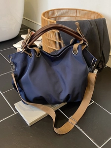 Retro deep blue canvas tote bag with leather handles and wide khaki shoulder strap