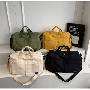 Detail showing high-capacity travel bags in olive, yellow, cream, and black colors