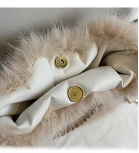 Detail of high-quality gold magnetic buckles on a fluffy faux fur tote bag with satin lining