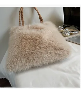 Detail of soft light beige faux fur tote bag with braided rope handles in a stylish setting