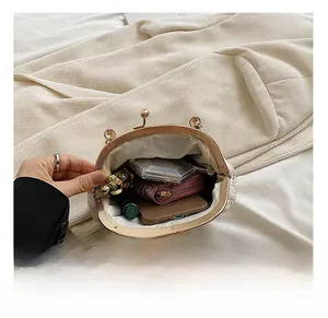 Detail view of the embroidered shell bag interior showing storage space for essentials