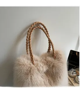 Detail of plush beige tote bag featuring woven leather handles and soft faux fur texture