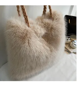 Detail of plush tote bag featuring braided leather handles and soft faux fur texture