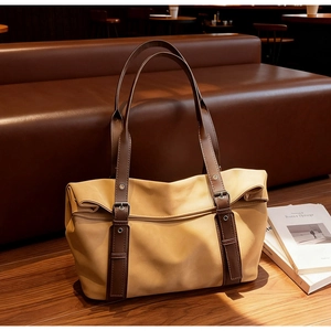 Détail d'un grand sac cabas rétro en cuir sur une table en bois dans un café chaleureux
