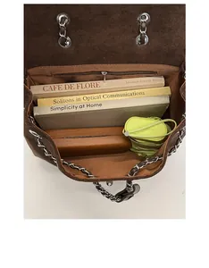 Overhead view showing large interior capacity of brown suede bag with silver chain