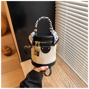 Detail of cylindrical bag with black and white heart scarf and metal double zipper