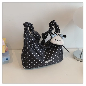 Polka dot canvas bag featuring ruffled handles and a cute plush puppy charm accessory