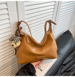 Brown hobo shoulder bag with metal plaque and cute leopard bow teddy bear charm