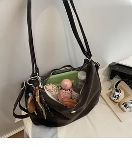 Sac à épaule marron foncé montrant un grand espace intérieur avec tablette et parapluie